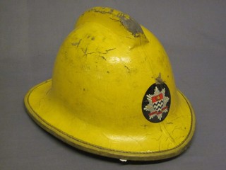 An old style London Fire Brigade yellow fireman's helmet
