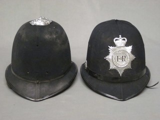 An Elizabeth II Devon & Cornwall Constabulary Policeman's helmet, complete with helmet plate, missing finial, together with a Policeman's riot helmet