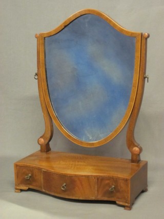 A Georgian style shield shaped dressing table mirror contained in a mahogany frame, raised on a serpentine base fitted 1 long and 2 short drawers, raised on bracket feet 16"