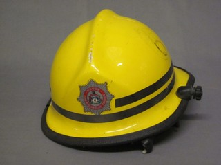 A modern Devon Fire & Rescue Service yellow Fireman's helmet