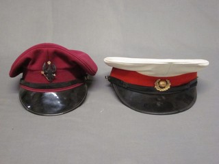 A Kings Royal Husaars Officer's peak cap together with a Royal Marines peak cap