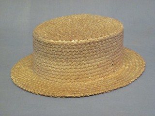 A straw boater by Battersby & Co