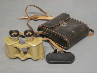 A pair of WWII yellow painted metal binoculars 6 x 30 contained in a black leather case marked Voigtlander