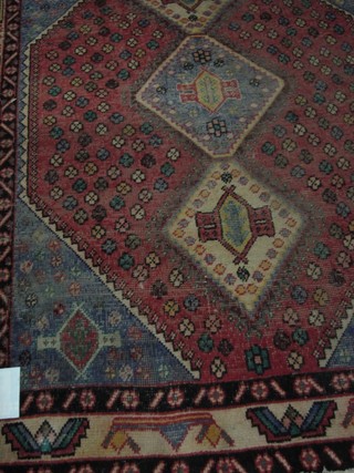 A contemporary red ground Turkey rug with 3 octagons the centre 79" x 63"