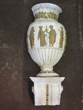 A plaster wall plaque in the form of a classical urn raised on a scroll 38"