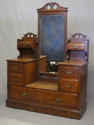 A Victorian walnut dressing chest with rectangular bevelled plate mirror to the centre, flanked by a pair of glove drawers, the base fitted 2 short drawers above 1 long drawer, raised on a platform base 50"