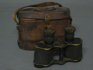 A pair of WWI War Office issue field glasses by A Kershaw & Sons Ltd no. 36602 contained in a brown leather carrying case