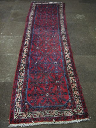 A contemporary red ground Persian runner 119" x 29"