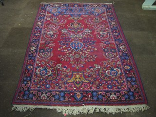 A red ground and floral patterned Persian carpet with central medallion 80" x 42", some wear,
