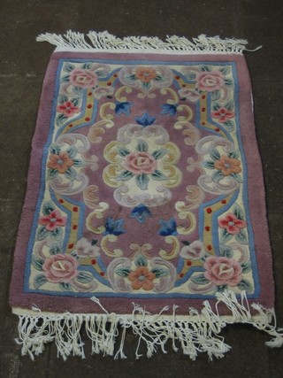 A plum coloured floral patterned Indian rug 37" x 25"