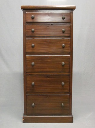 A stained pine Wellington style chest of 6 long drawers 19"