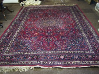 A good quality red ground and floral patterned Persian carpet with central floral medallion within multi row borders 135" x 101"