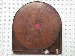 An arch shaped wooden bagatelle board