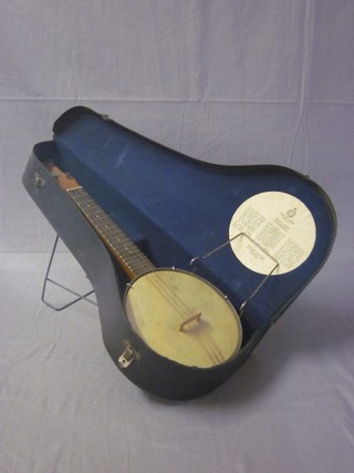 A John Gray & Sons 4 stringed banjo, complete with fibre case