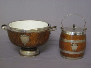 A circular coopered oak biscuit barrel with silver plated mounts together with a twin handled fruit bowl with ceramic liners