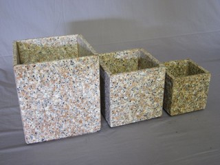 A set of 3 square graduated "granite" planters