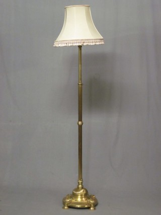 A reeded brass adjustable standard lamp