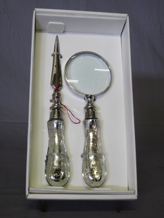 A magnifying glass together with a matching letter opener