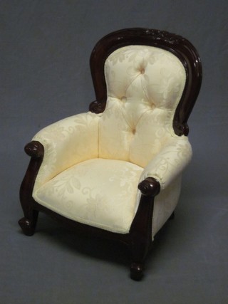 A childs Victorian style show frame mahogany armchair, upholstered in yellow material and raised on cabriole supports