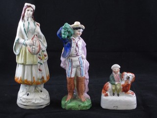A 19th Century Staffordshire figure in the form of a seated boy with dog 2 1/2", a Staffordshire figure of a standing gentleman 5" and a lady with mandolin 6"