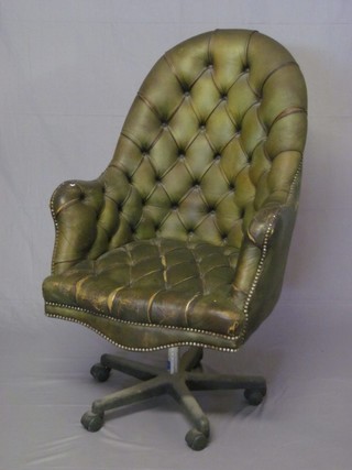 A green leather upholstered tub back revolving office chair