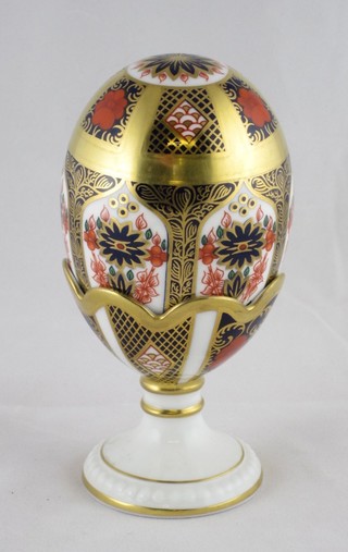 A Royal Crown Derby Imari patterned model of an egg with egg cup, the base marked Old Imari 1128 LVI 6"