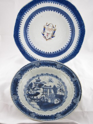 An 18th Century Oriental circular blue and white porcelain bowl with armorial decoration 9 1/2" and an Oriental blue and white porcelain bowl 8" - cracked and chipped