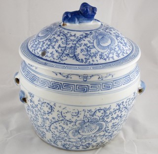 An Oriental blue and white jar and cover, the lid decorated a seated Dog of Fo 9"
