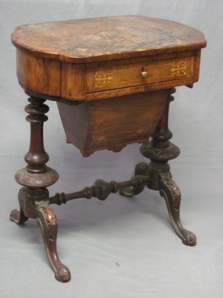 A Victorian oval figured walnut work table, the base fitted a drawer above a deep basket, raised on turned supports with H framed stretcher 24", top bubbling and requires some attention,