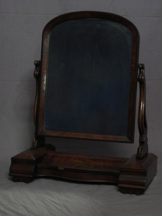 A Victorian mahogany arch plate dressing table mirror contained in a mahogany swing frame, the base of serpentine outline fitted a glove box with hinged lid and and 2 drawers to the side 26"