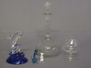 A mallet shaped decanter and stopper, a figure of a dolphin and a small brandy balloon