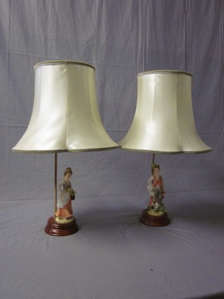 A pair of biscuit porcelain figures in the form of a boy and girl mounted as table lamps 8"