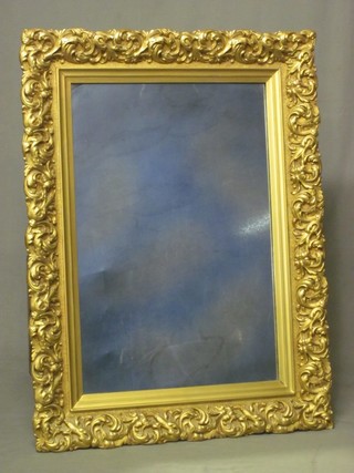 A rectangular plate wall mirror contained in a decorative gilt frame 39"