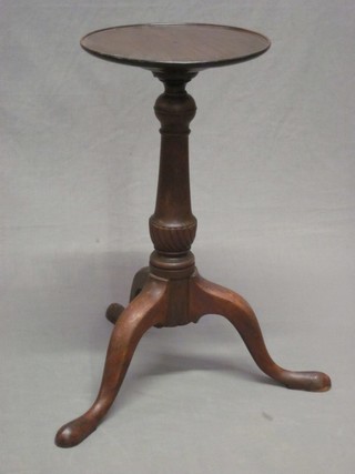 A 19th Century style circular turned mahogany kettle stand, raised on pillar and tripod base
