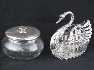 A cut glass salt with pierced white metal mounts in the form of a swan and a cut glass powder bowl with silver lid