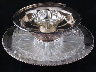 A circular silver plated Lazy Susan with glass liners 13", a circular cake basket with swing handle and a small silver plated dish