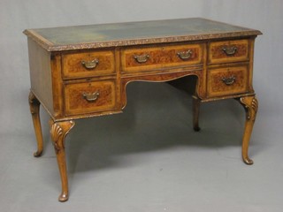 A Queen Anne style writing table with green inset leather writing surface above 1 long drawer, flanked by 4 short drawers, raised on carved cabriole supports 44"