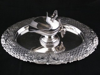 A silver plated sugar scuttle and an oval pierced and embossed silver plated bread border holder, no board,