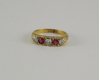 A lady's 18ct gold dress ring set 2 rubies flanked by 2 diamonds