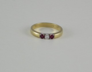 A lady's 14ct yellow gold dress ring set a diamond supported by 2 rubies