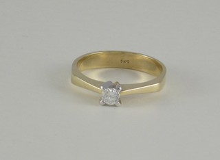 A lady's 14ct yellow gold dress ring set a solitaire diamond