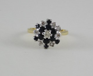 An 18ct white gold dress ring set sapphires and diamonds
