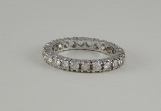 A white metal full eternity ring set white stones