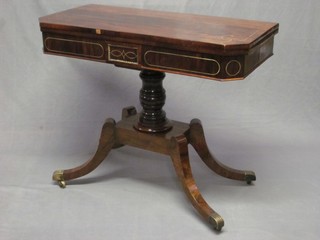 A William IV rosewood and brass inlaid card table, raised on a column with platform base with sabre supports ending in brass caps and castors 36"