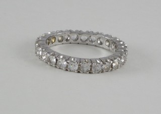 A white metal full eternity ring set white stones