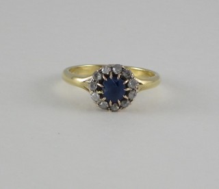 An 18ct yellow gold cluster ring set a sapphire surrounded by diamonds