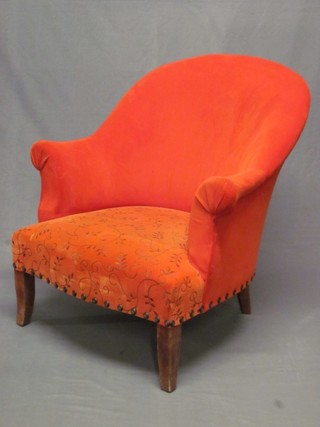 A mahogany framed armchair upholstered in bright orange material