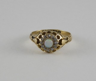 A Victorian 18ct yellow gold dress ring set an opal surrounded by diamonds