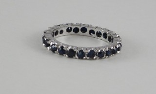 A white metal full eternity ring set blue stones