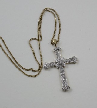 A 9ct gold cross set diamonds, hung on a gold chain